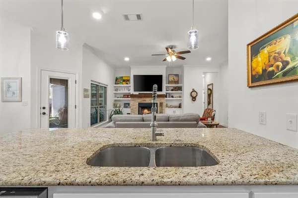 a view of kitchen sink microwave and refrigerator