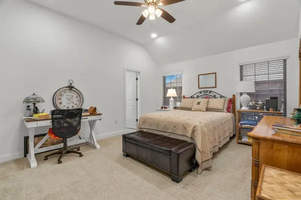 a bedroom with a bed a desk and chair