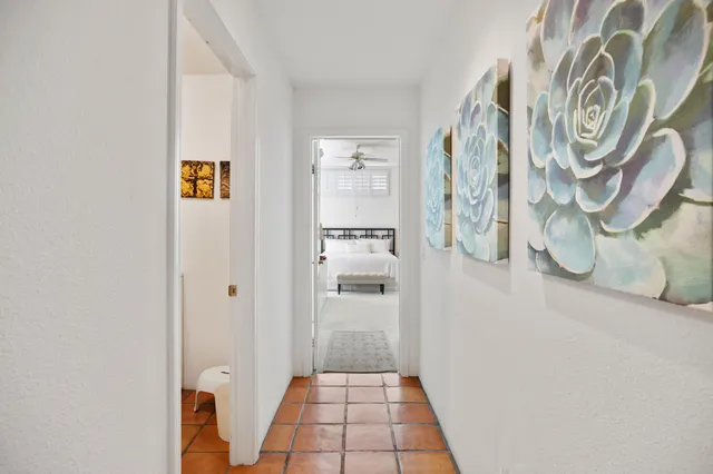 a bathroom with a granite countertop tub a double vanity sink and mirror