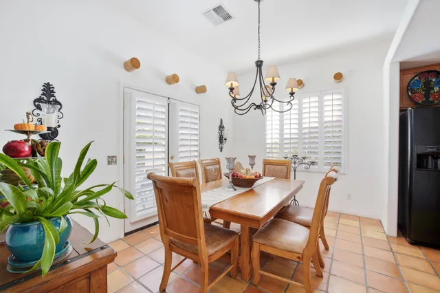 a living room with furniture a window and a chandelier