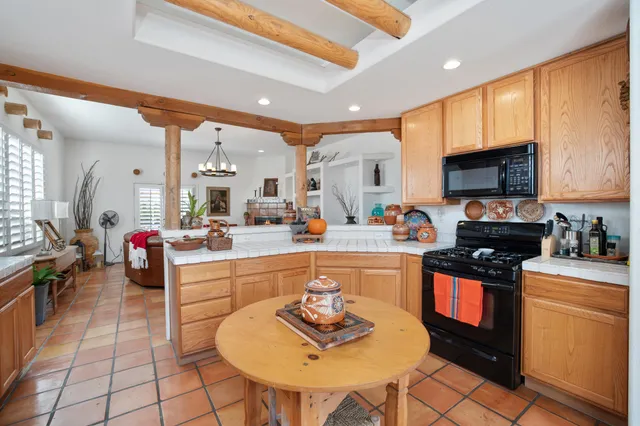 a kitchen with stainless steel appliances a sink a stove and cabinets