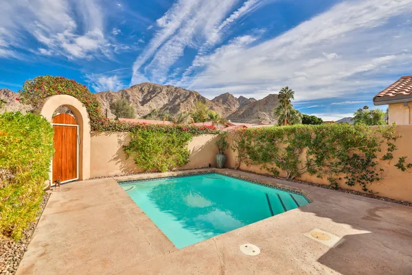 a view of a chairs and table in backyard