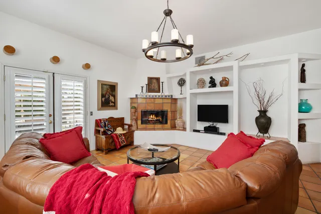 a living room with furniture chandelier and a large window