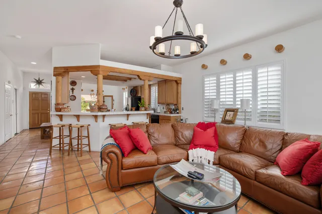 a view of a patio with table and chairs and potted plants