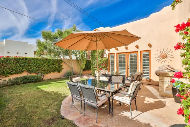 a view of an chairs with a table in the patio