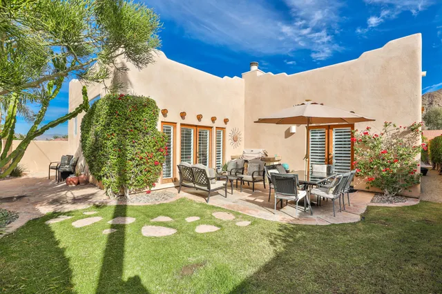 a view of a chairs and table in the patio