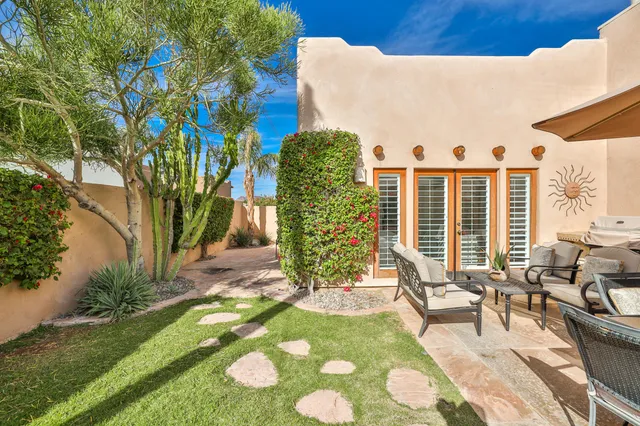 a view of a chairs and table in backyard