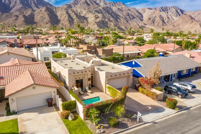 an aerial view of residential houses with outdoor space