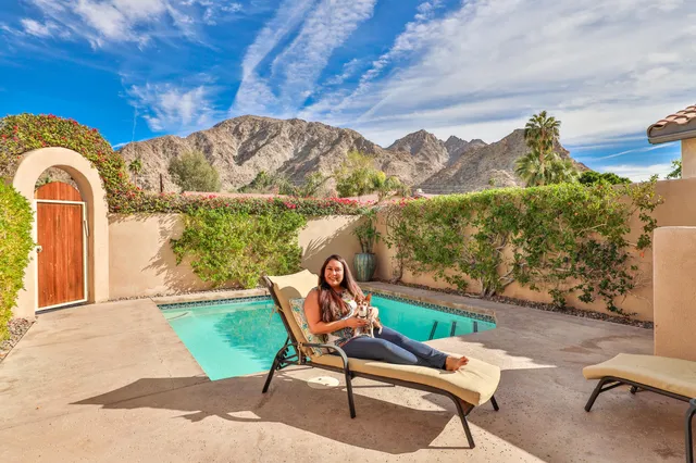 a bedroom with a bed and a potted plant