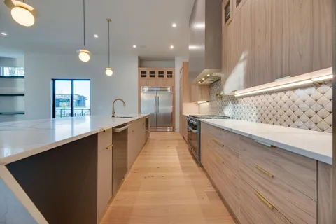 a kitchen with a refrigerator and a sink