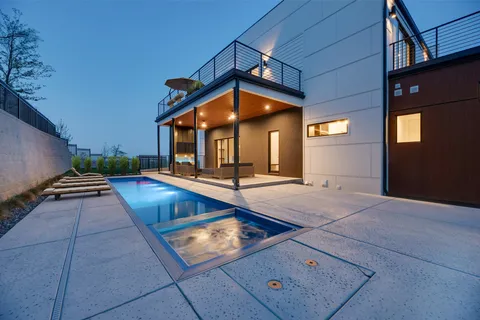 a view of a house with pool table and chairs