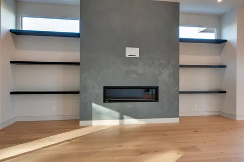 a view of an empty room with a chandelier fan
