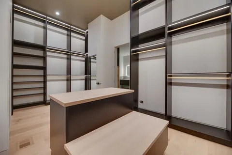 an empty room with ceiling fan and windows