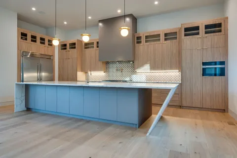 a view of a kitchen with a sink and a refrigerator