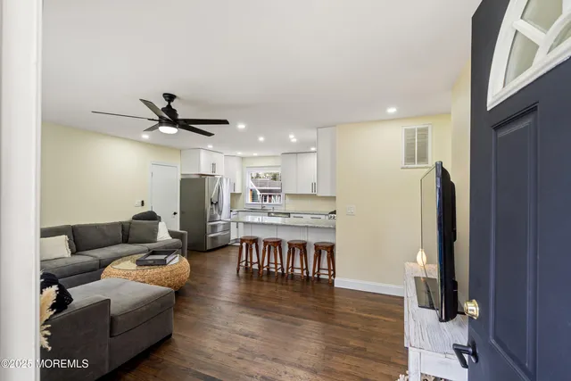 a living room with furniture and a wooden floor