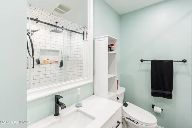 a bathroom with a sink toilet and shower