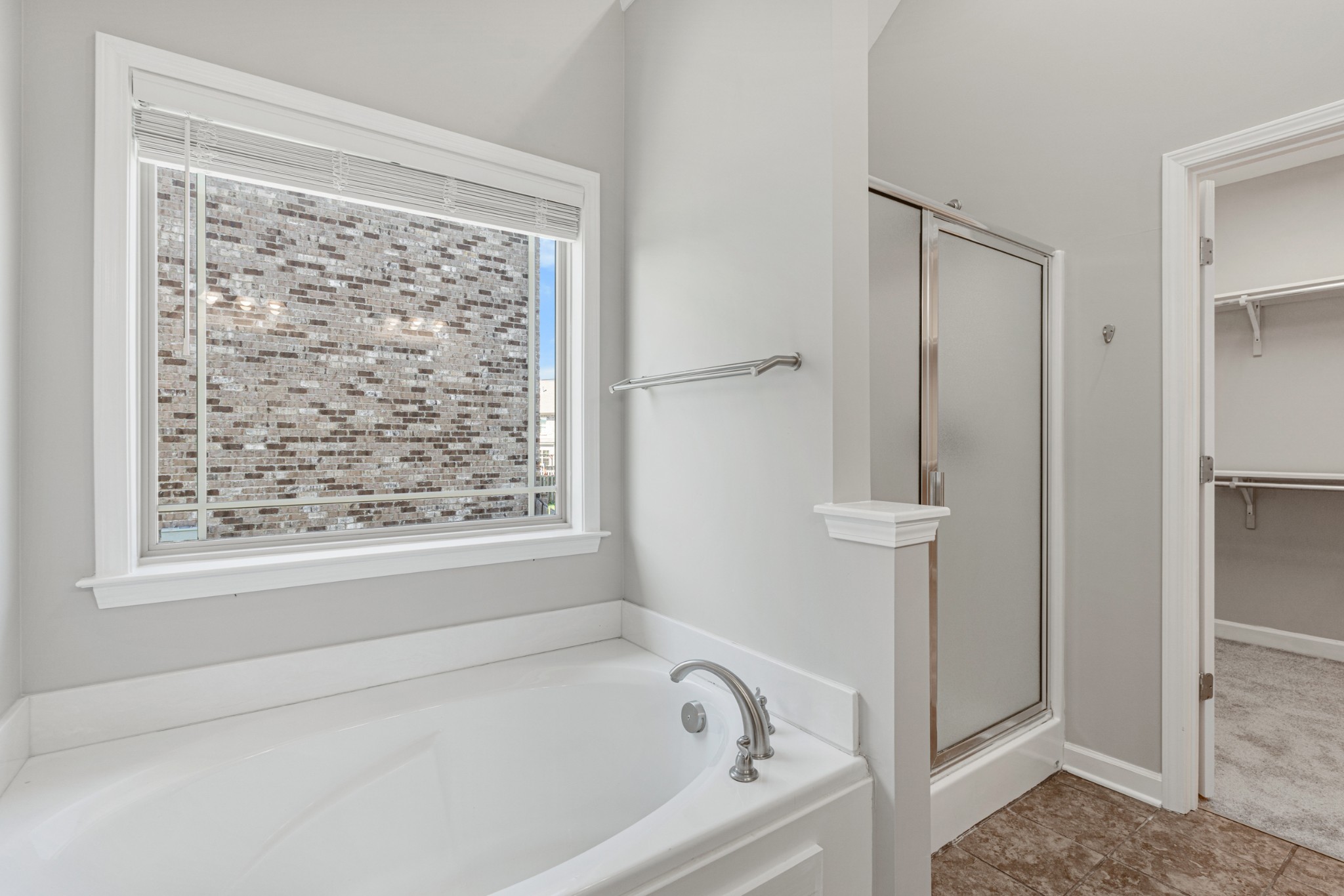 5007 Speight Street Spring Hill, TN 37174 - Photo 16 of 33 a white bath tub sitting next to a shower