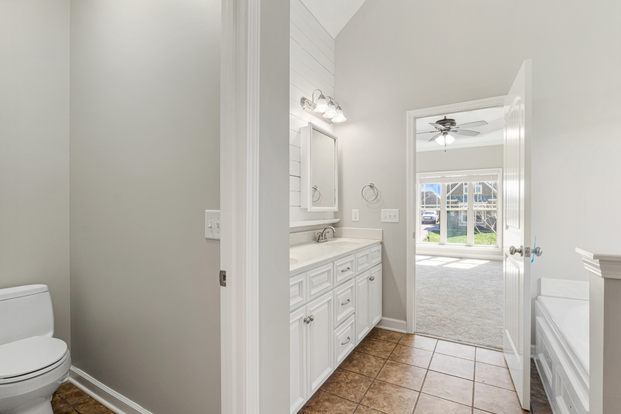 5007 Speight Street Spring Hill, TN 37174 - Photo 18 of 33 a bathroom with a granite countertop sink a toilet and a shower