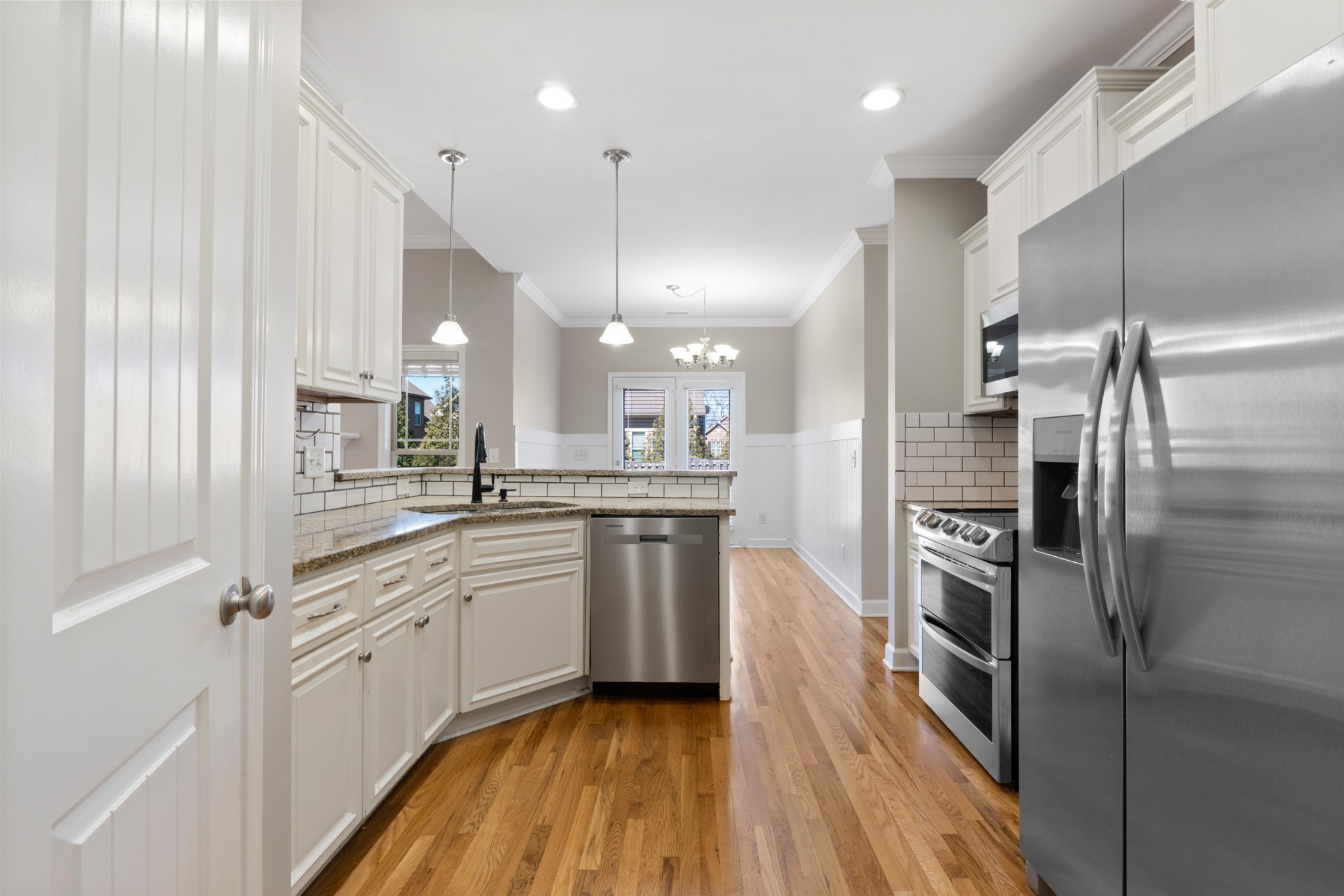 5007 Speight Street Spring Hill, TN 37174 - Photo 8 of 33 a kitchen with white cabinets and stainless steel appliances