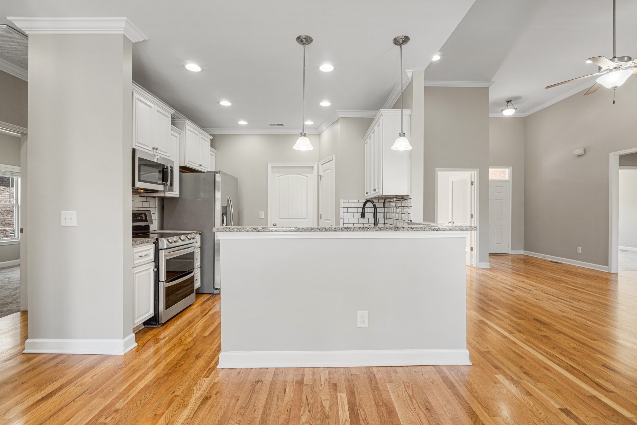 5007 Speight Street Spring Hill, TN 37174 - Photo 9 of 33 a view of kitchen with kitchen island wooden floor appliances and cabinets