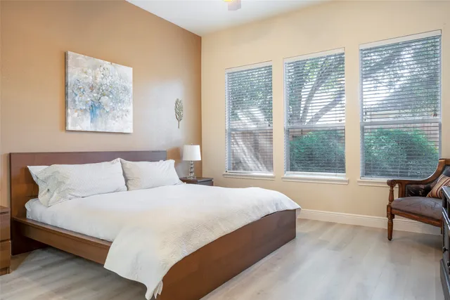 a bedroom with a bed and a large window