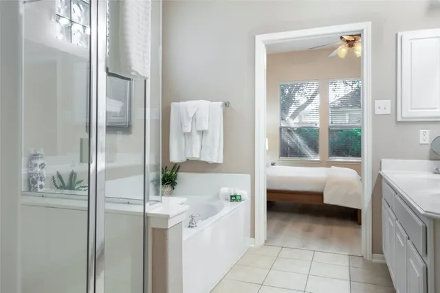 a bathroom with a tub sink and mirror