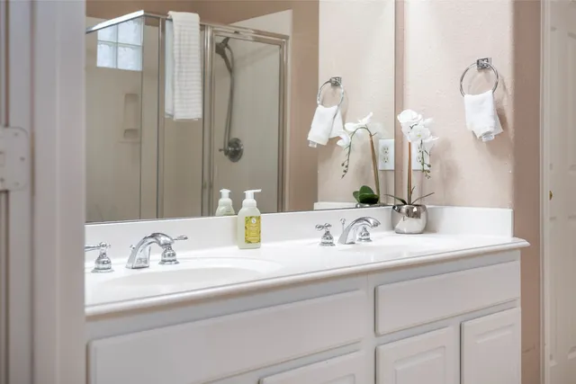 a bathroom with a double vanity sink and a mirror
