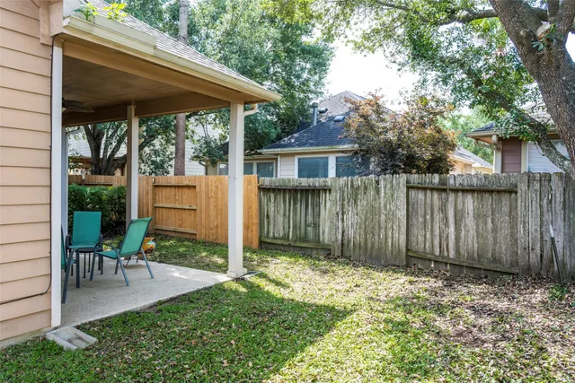 a view of backyard with small cabin and a chair