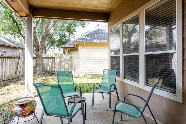 a view of a chair and tables in the balcony