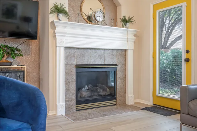 a living room with a fireplace and a flat screen tv