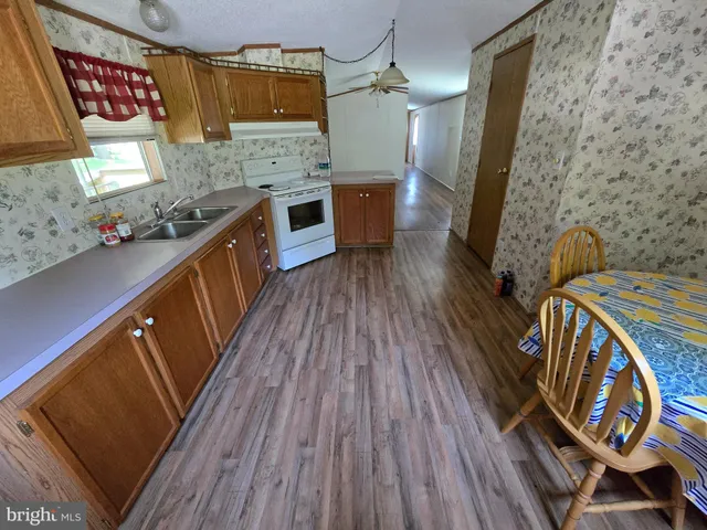 a view of a hardwood floor and a sink