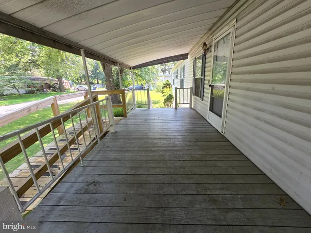 a view of a porch with wooden floor