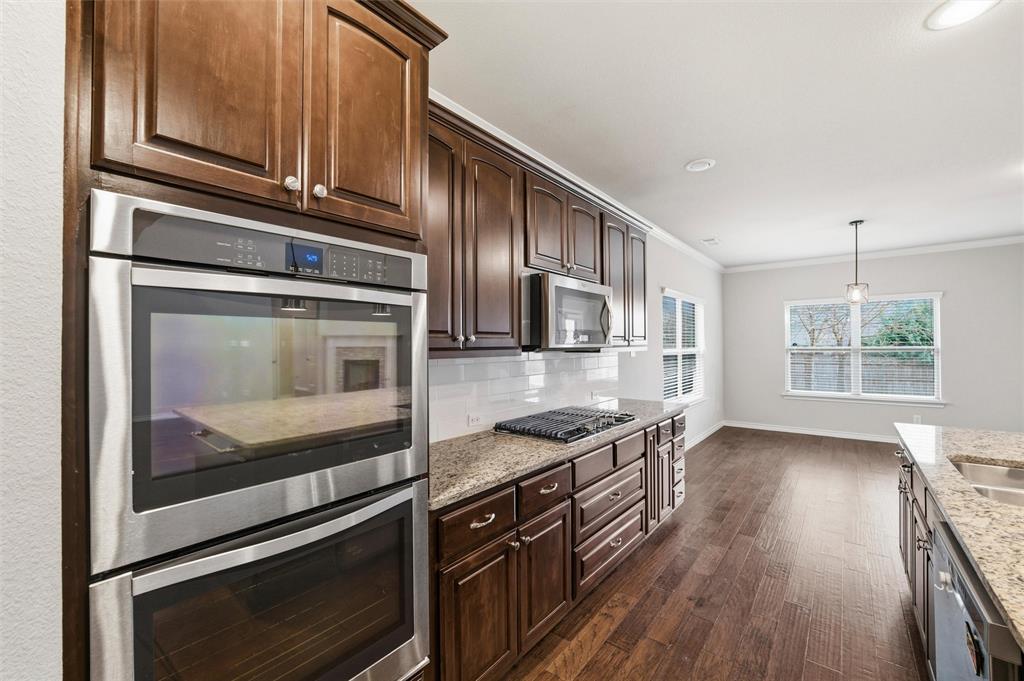 420 Prairie Run Aledo, TX 76008 - Photo 14 of 38 a kitchen with stainless steel appliances granite countertop a stove and a microwave