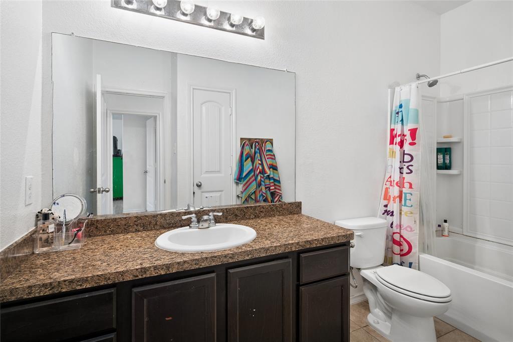 324 Fairgrounds Lane Ponder, TX 76259 - Photo 19 of 40 a bathroom with a granite countertop sink and a mirror