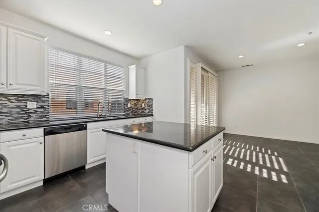 a kitchen with stainless steel appliances a sink stove and cabinets