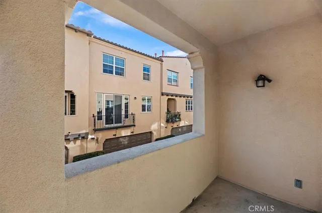 a view of a house with a big yard plants and large trees