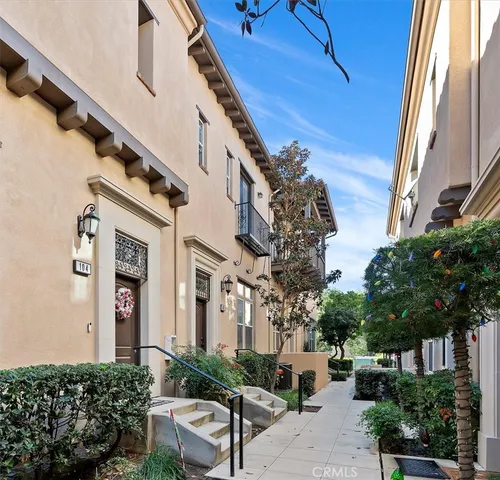 a front view of a house with a tree
