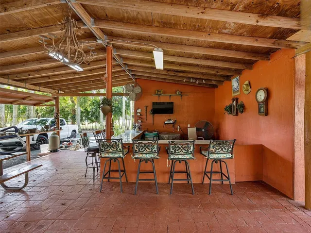 a outdoor space with lots of chairs and chandelier