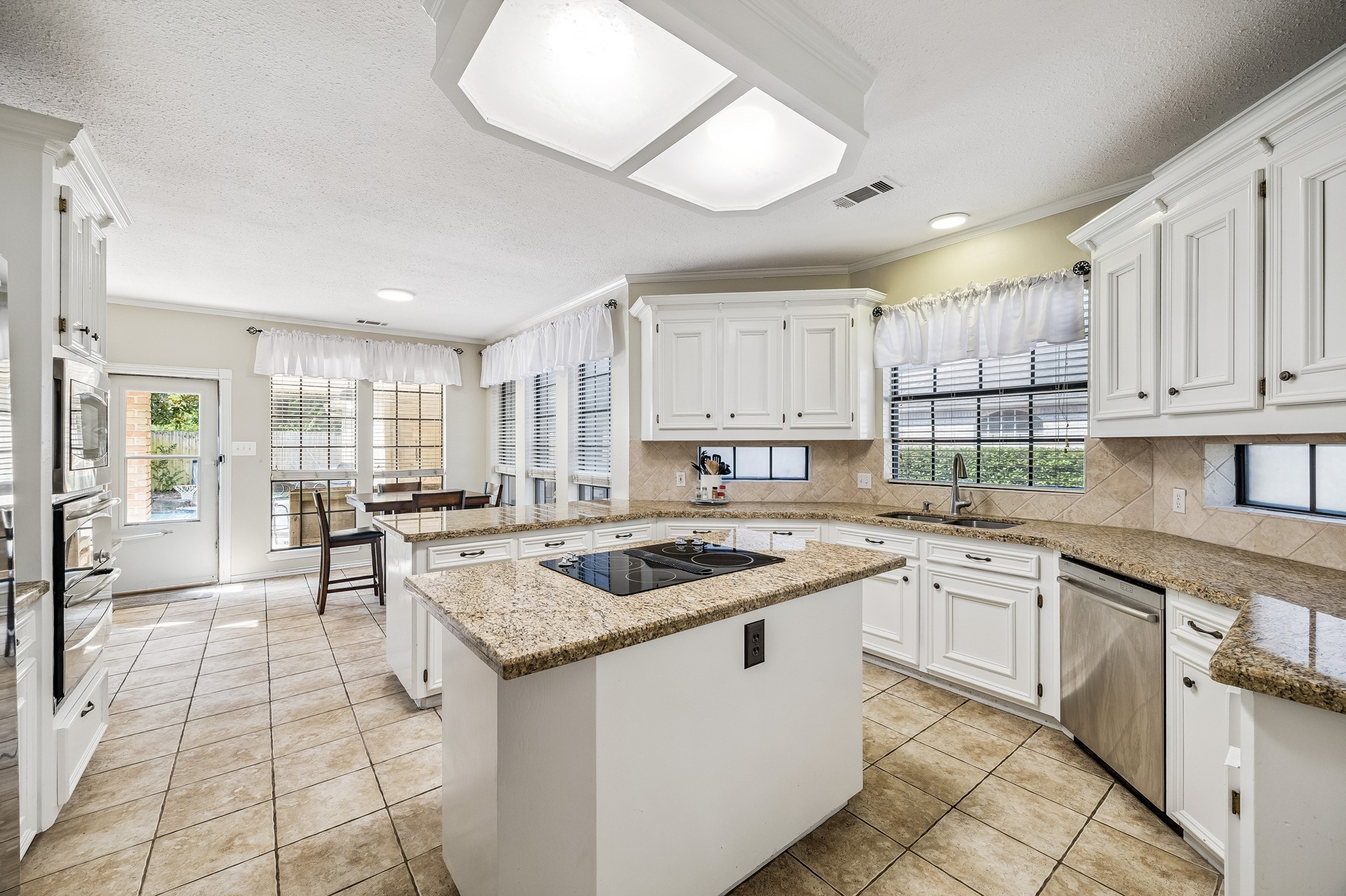 5823 Ashmere Lane Spring, TX 77379 - Photo 15 of 35 a kitchen with granite countertop a sink and cabinets