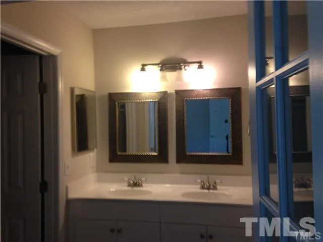 a bathroom with a double vanity sink and a mirror