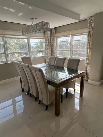 a view of a dining room with furniture and window