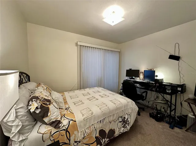 a bedroom with a bed and a table