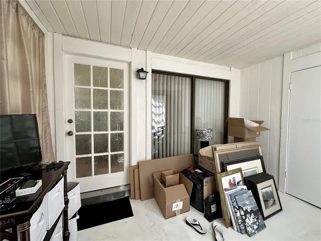 a room with furniture a flat screen tv and a window