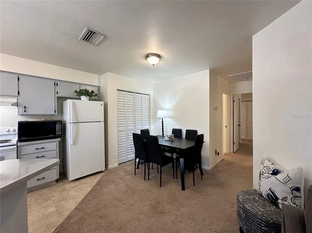 a view of a dining room with furniture and a chandelier