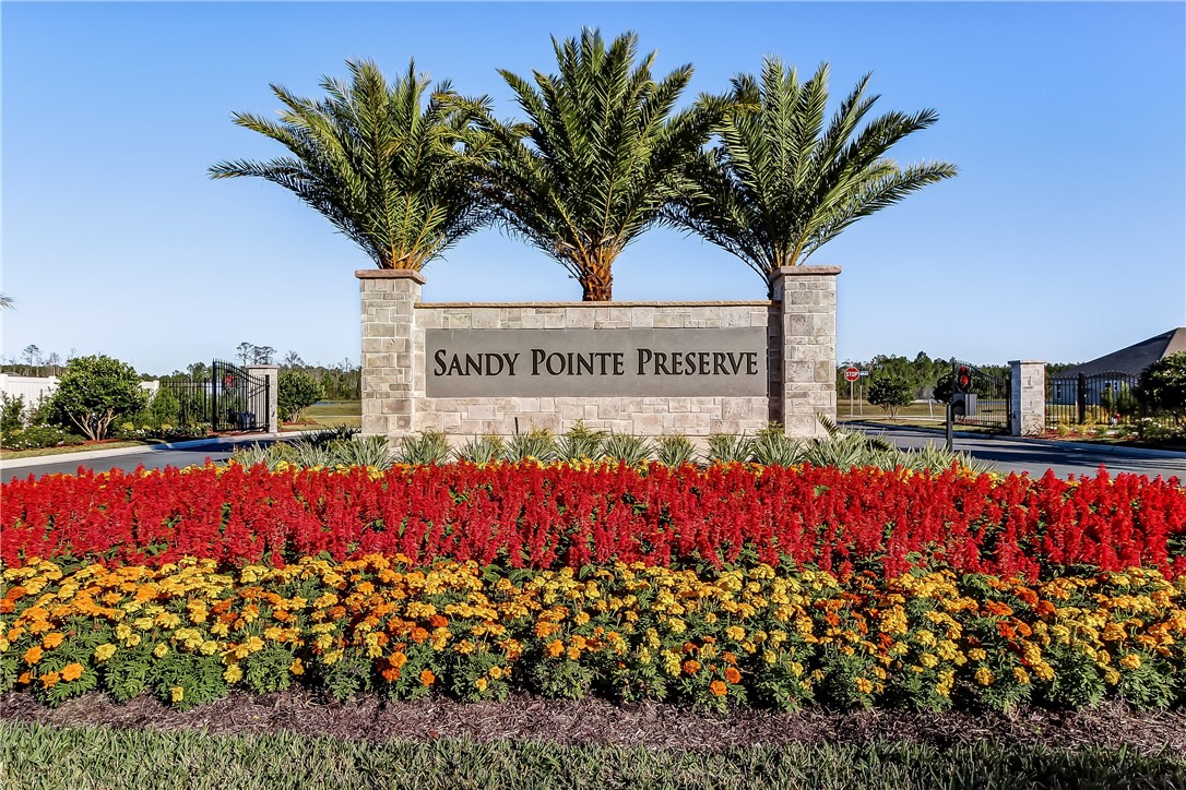 95230 Sandy Pointe Drive Fernandina Beach, FL 32034 - Photo 3 of 3 a view of a sign board with flower plants