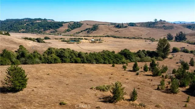 an aerial view of mountain with yard