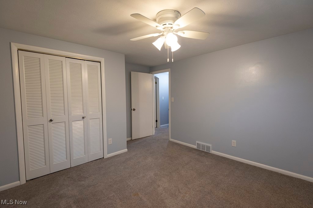 11819 Sheldon Road Mantua, OH 44255 - Photo 18 of 46 Unfurnished bedroom 2 with carpet flooring, ceiling fan, and a closet