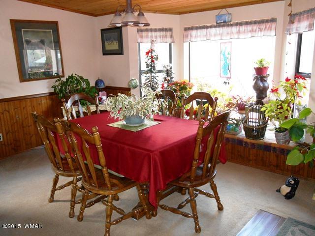 2849 Lodgepole Road Overgaard, AZ 85933 - Photo 13 of 67 a view of a dining room with furniture and a window