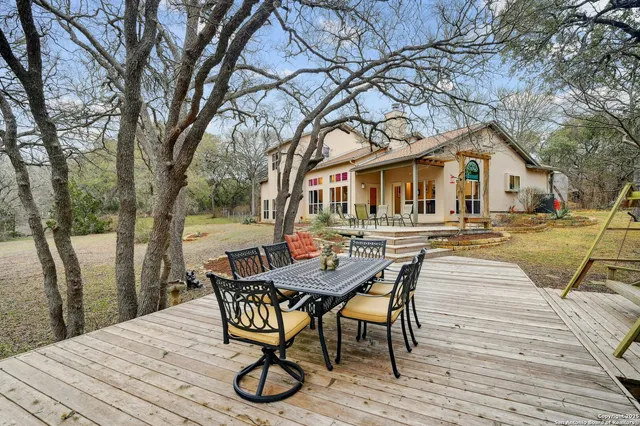 a view of a patio with table and chairs and wooden floor