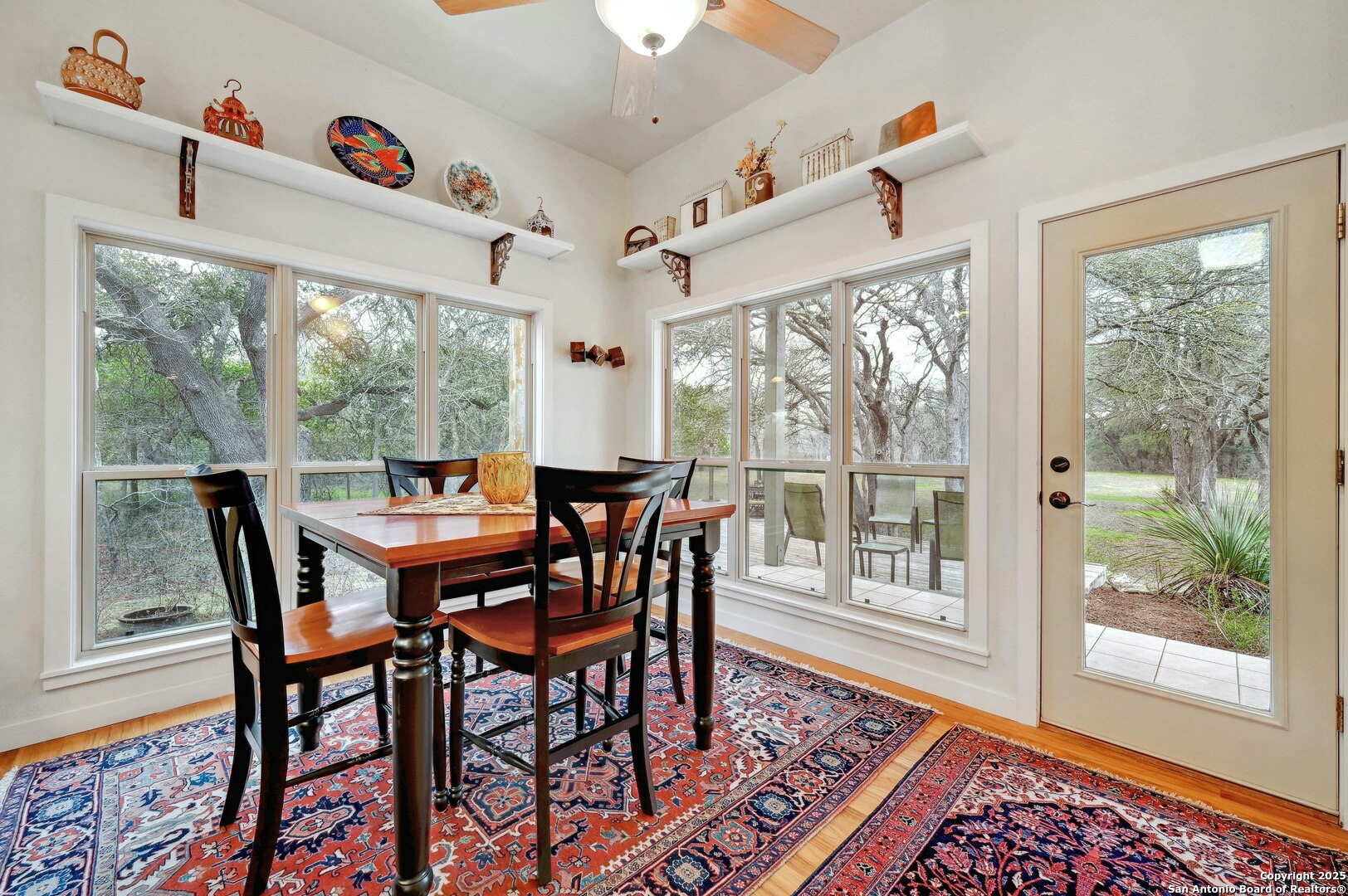2147 Tejas Trail Blanco, TX 78606 - Photo 15 of 33 a view of a dining room with furniture large windows and wooden floor